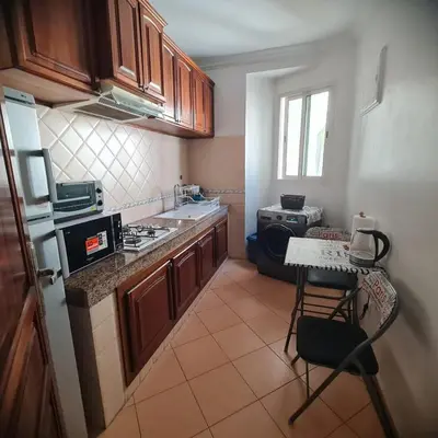 a small kitchen with a stove and a counter top at Appartement confortable et bien situé in Casablanca
