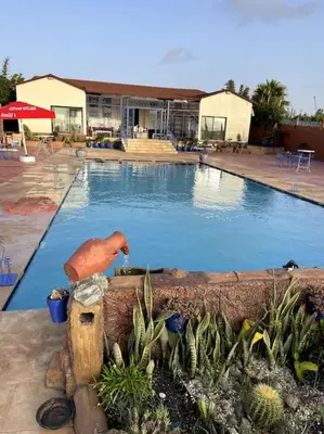 a large swimming pool with a large swimming pool at Jnane Jawhara Skhirat studio in Skhirat
