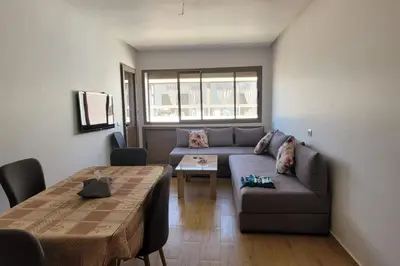 a living room with a couch and a table at Appart à Malaga Beach Mansouria in Mansouria