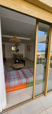 a view of a living room through a glass window at le carrousel Rabat Océan in Kouas