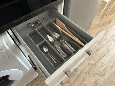 a drawer in a kitchen with utensils in it at Cosy and practical apartment in Maarif