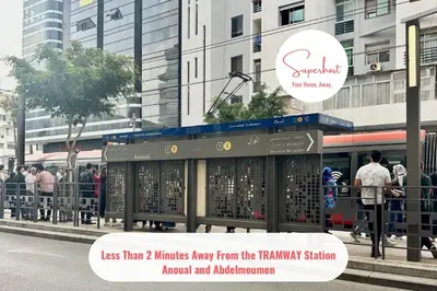 a bus stop with people waiting for a bus at Cosy and practical apartment in Maarif
