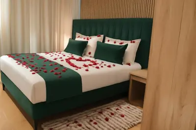 a bedroom with a bed with red flowers on it at studio by rent inn in Rabat