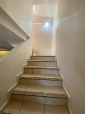 a staircase in a building with a light on it at duplex in Oulad Lahsene
