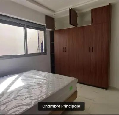 a bedroom with a bed and a large window at Luxury apartment in Casablanca