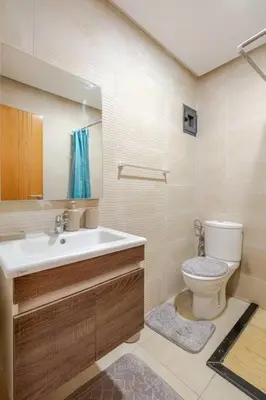 a bathroom with a toilet and a sink at Residence GYA Beach - Luxe Moderne et Confort à Harhoura accès plage in Temara