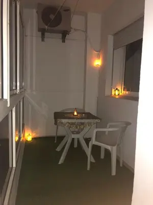 a table and a chair in a room with a candle at Casablanca in Casablanca