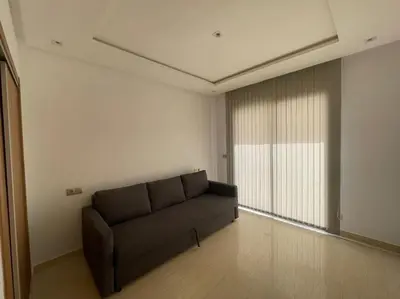 a living room with a couch and a window at Bel appartement in Casablanca
