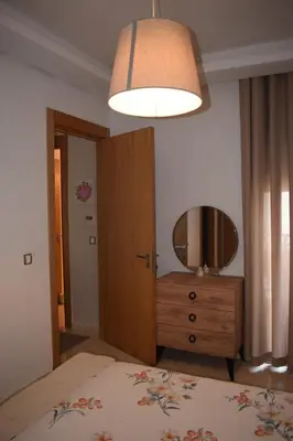 a bedroom with a bed and a mirror and a dresser at Appartement Confortable en Résidence Privée avec Piscine in Pont Blondin