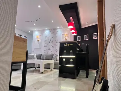 a living room with a piano and a couch at Ricks appartement in Casablanca
