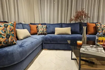 a blue couch with pillows on it in a living room at Emplacement Central & So Stylish Près du Consulat Américain 2 minutes de Twin Center Gauthier Casablanca in Casablanca