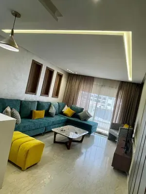 a living room with a blue couch and a table at Appartement cosy in Casablanca