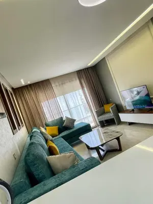 a living room with a green couch and a table at Appartement cosy in Casablanca