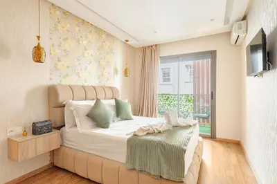 a bedroom with a large bed and a window at AS140 élégant coeur de Casablanca avec Wifi Parking et Tramway in Casablanca
