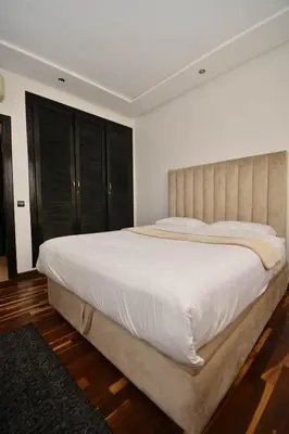 a bedroom with a large bed with white sheets at Lovely 2 bedroom flat in Ain Diab in Casablanca