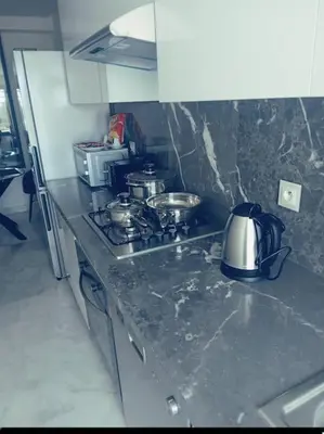 a kitchen with a stove with pots and pans on it at Maarif dar zara 2 chambres ,Wifi ,Parking Gratuit in Casablanca