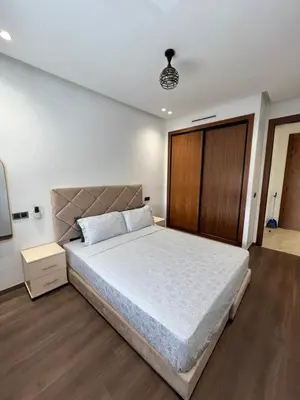 a bedroom with a large bed and a wooden door at Studio en plein centre de Casablanca in Casablanca