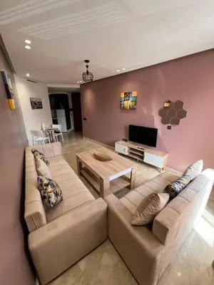 a living room with a couch and a table at Studio en plein centre de Casablanca in Casablanca