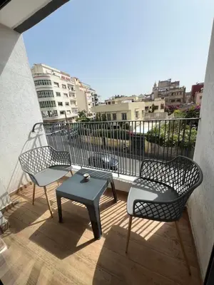 two chairs and a table on a balcony at Studio en plein centre de Casablanca in Casablanca