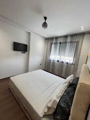 a bedroom with a bed and a couch at Studio en plein centre de Casablanca in Casablanca