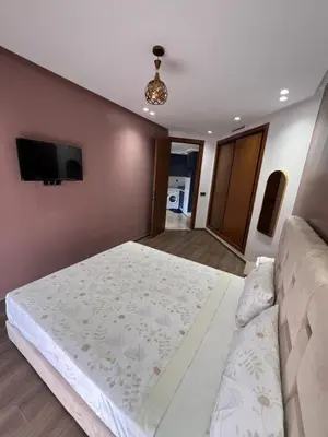 a bedroom with a large bed and a couch at Studio en plein centre de Casablanca in Casablanca