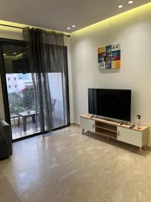 a living room with a flat screen tv on a wall at Studio en plein centre de Casablanca in Casablanca