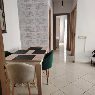 a dining room with a table and chairs at Élégance familiale à Skhirate près de la plage et la ville in Skhirat
