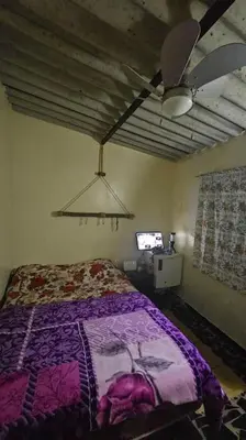 a bedroom with a bed and a ceiling fan at Ferme Benslimane 30 min de rabat in O Ben Slimane