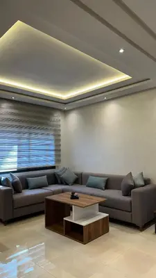 a living room with a couch and a coffee table at Cosy Suite Appart in Bouznika