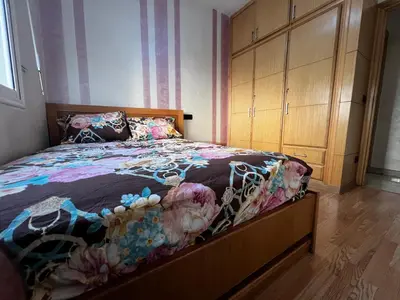 a bedroom with a large bed and a dresser at Appartement à 5min de Casanearshore in Casablanca