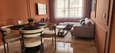 a living room with a table and chairs and a couch at The 23 Princesses by IB Signature - Stylish 2 Bedroom Apt with Wifi, Self check-in - 24 x7 Security - City View - Walk to Cafes! City Centre in Casablanca