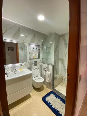 a bathroom with a toilet and a sink and a tub at Appartement Oasis Beach in Mohammedia
