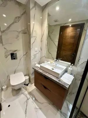 a bathroom with a sink and a toilet and a mirror at Studio pivoine 27 CFC à 2mn in Casablanca