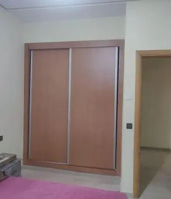 a large wooden sliding door in a room at appartement calme in Casablanca