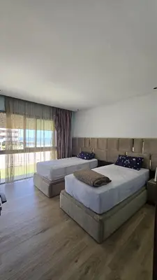 a bedroom with two beds and a large window at Marina casablanca in Casablanca