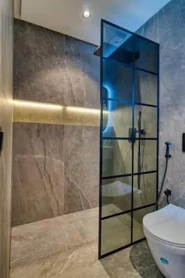 a bathroom with a glass shower with a toilet at Prestigieux Studio- Vue dégagée in Casablanca