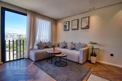 a living room with a couch and a table at Prestigieux Studio- Vue dégagée in Casablanca