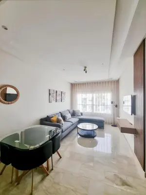 a living room with a couch and a table at Cosy Aparts, 2BR, downtown, near tramway in Casablanca