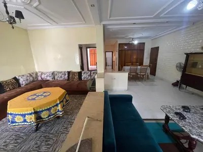 a living room with a couch and a table at Appt à Harhoura in El Harhoura