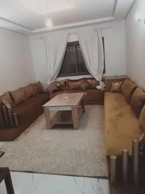 a living room with a couch and a coffee table at Riad Ain Atiq in Temara