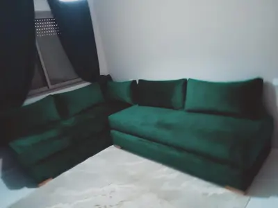 a green couch sitting in a living room at Riad Ain Atiq in Temara