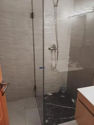 a shower with a glass door in a bathroom at Riad Ain Atiq in Temara