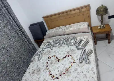 a bed with a heart written on it at Appartement vues piscine in Mansouria