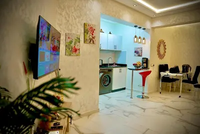 a living room with a kitchen and a dining room at appartement luxe rabat ville in Rabat
