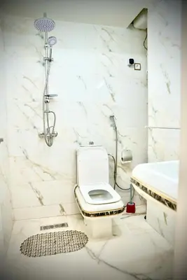 a bathroom with a toilet and a sink at appartement luxe rabat ville in Rabat