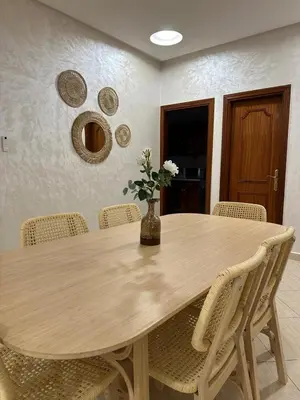 a dining room table with chairs and a vase with flowers at Perfect for Families & Friends! King & Queen beds in Casablanca