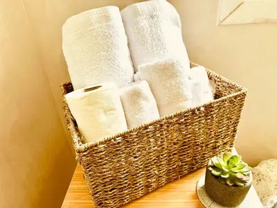 a basket of towels on a table with a plant at Perfect for Families & Friends! King & Queen beds in Casablanca