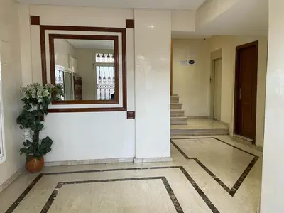 a hallway of a building with a mirror and a plant at Perfect for Families & Friends! King & Queen beds in Casablanca