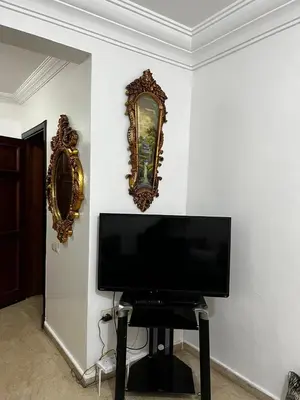 a flat screen tv on a wall with a mirror at Studio meublée free in Casablanca