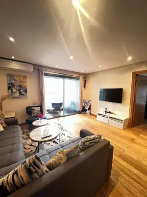 a living room with a couch and a tv at Oean view apartment Marina Casablanca in Casablanca